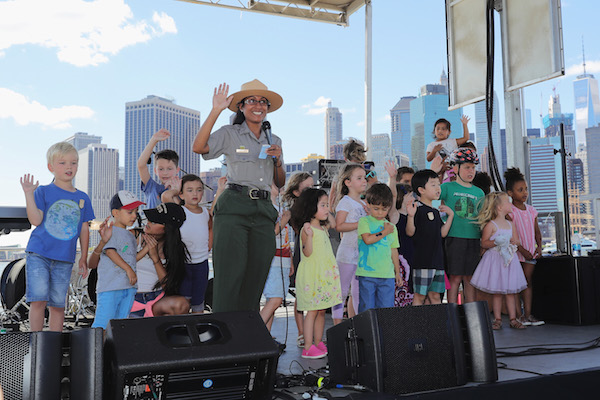 NEW YORK, NY - AUGUST 22: Visitors make the Junior Ranger Pledge during the National Park Foundation's #FindYourPark event, celebrating the National Park Service's centennial at Brooklyn Bridge Park on August 22, 2016 in New York City. (Photo by Neilson Barnard/Getty Images for National Park Service)