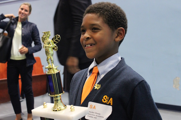 Jayden Steele smiles wide after earning the Grade 2 spelling bee title.