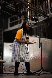 Mary shouts with joy after spelling “ammunition” to win the Grade 3-4 spelling bee.