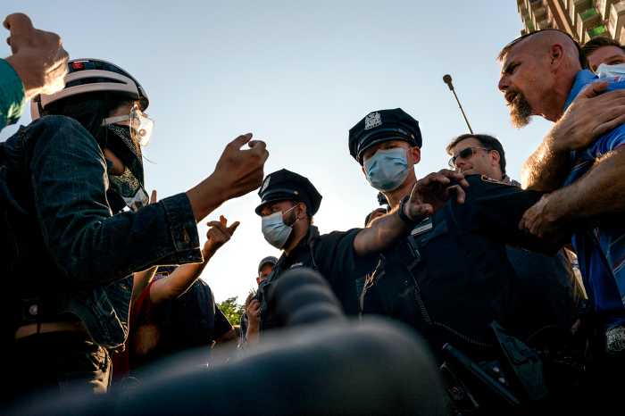 Scuffles broke out immediately after the Black Lives Matter protesters arrived at the 68 Precinct as NYPD officers stepped in and separate the two sides.