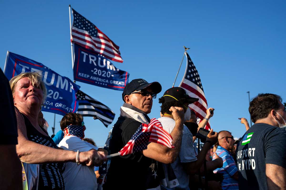 A NYPD supporter flexing his arm towards BLM protesters. Over 100 pro-NYPD protesters were present at the rally on Sunday (Photo by Tsubasa Berg)