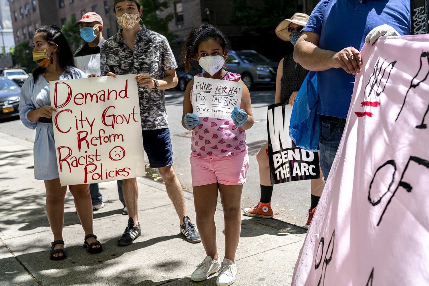 Amanda Vidal (center) came across and joined the March in front of one of the Fulton Houses in Chelsea. (Photo by Tsubasa Berg)
