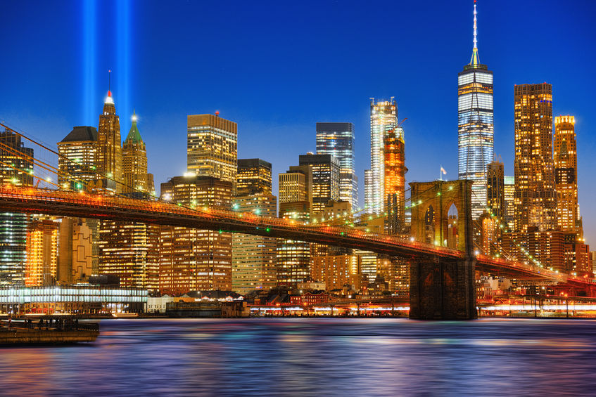 New York night view of the Lower Manhattan and the Brooklyn Bridge across the East River.