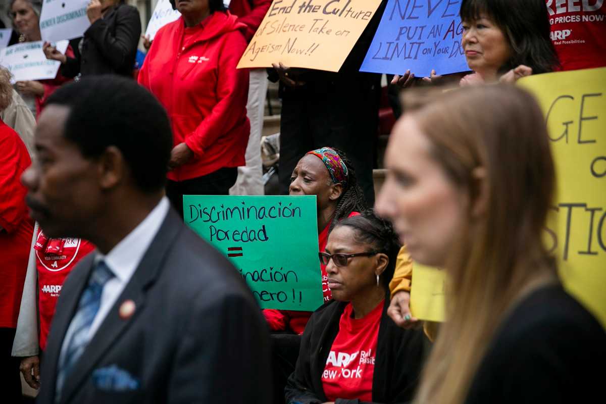 Age Justice Advocates and Aging New Yorkers protesting with colorful signs that read "End the Culture of silence takeon Agism Now!!" "Never put an Age limit on your Driver License" "Discriminacion poredad"