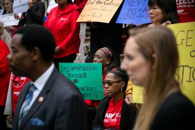 Age Justice Advocates and Aging New Yorkers protesting with colorful signs that read "End the Culture of silence takeon Agism Now!!" "Never put an Age limit on your Driver License" "Discriminacion poredad"