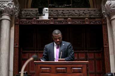 NYS Senator Brian A. Benjamin looking down to his notes at the NYS Senate Chamber