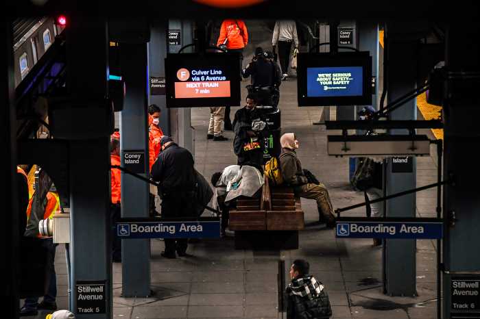 Homeless men on the subway terminal platfrom being reached out by city homeless agents