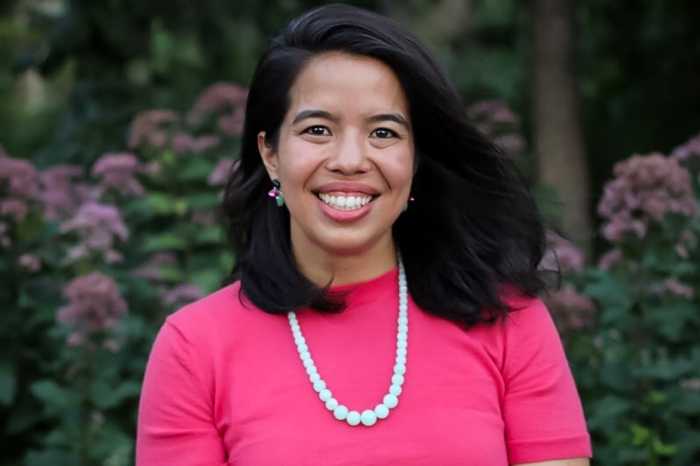 Tricia Shimamura in pink shirt, smiling to the camera