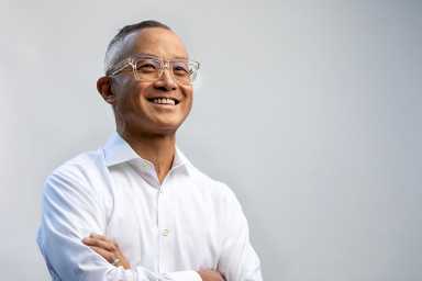 Art Chang with his arms crossed and smiling off camera angle