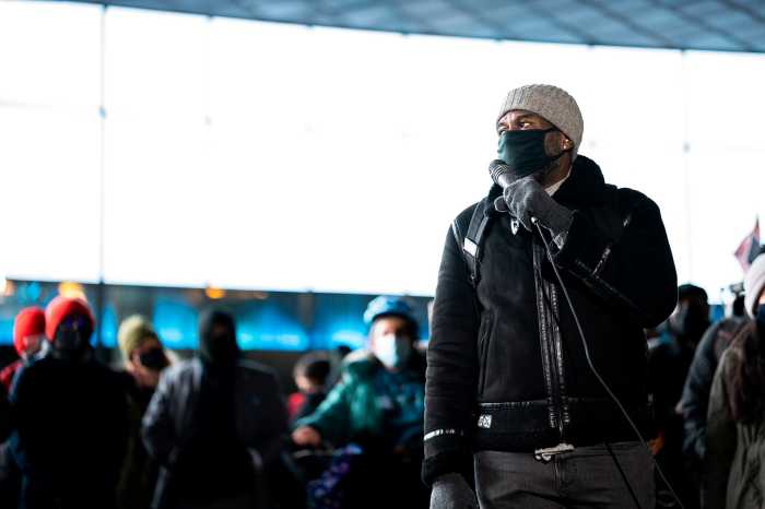 Public Advocate Jumaane Williams speaking at Barclay Center in front of a rally with his mask on