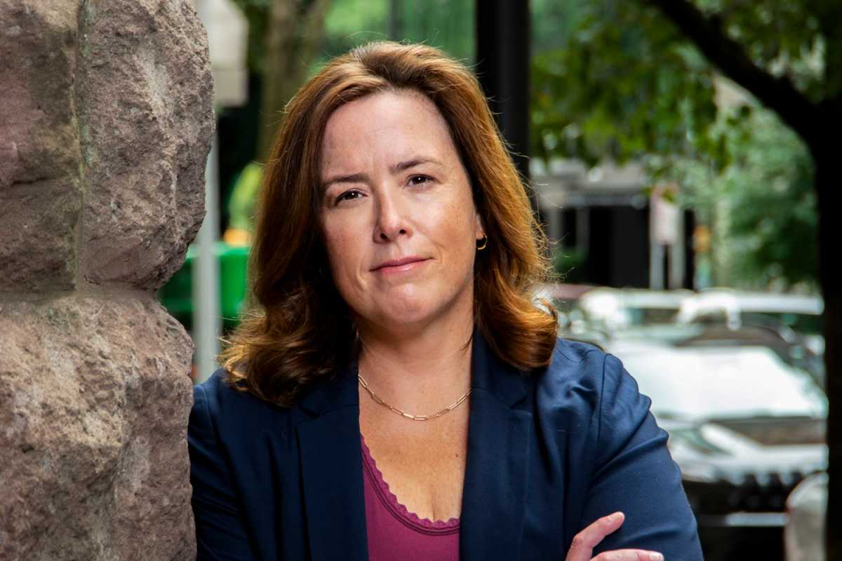 Liz Crotty looking at the camera with her arm crossed outside