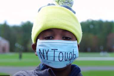 A boy wearing a mask