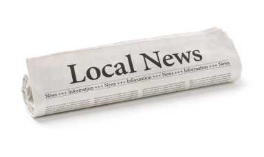 Rolled newspaper with the headline Local News